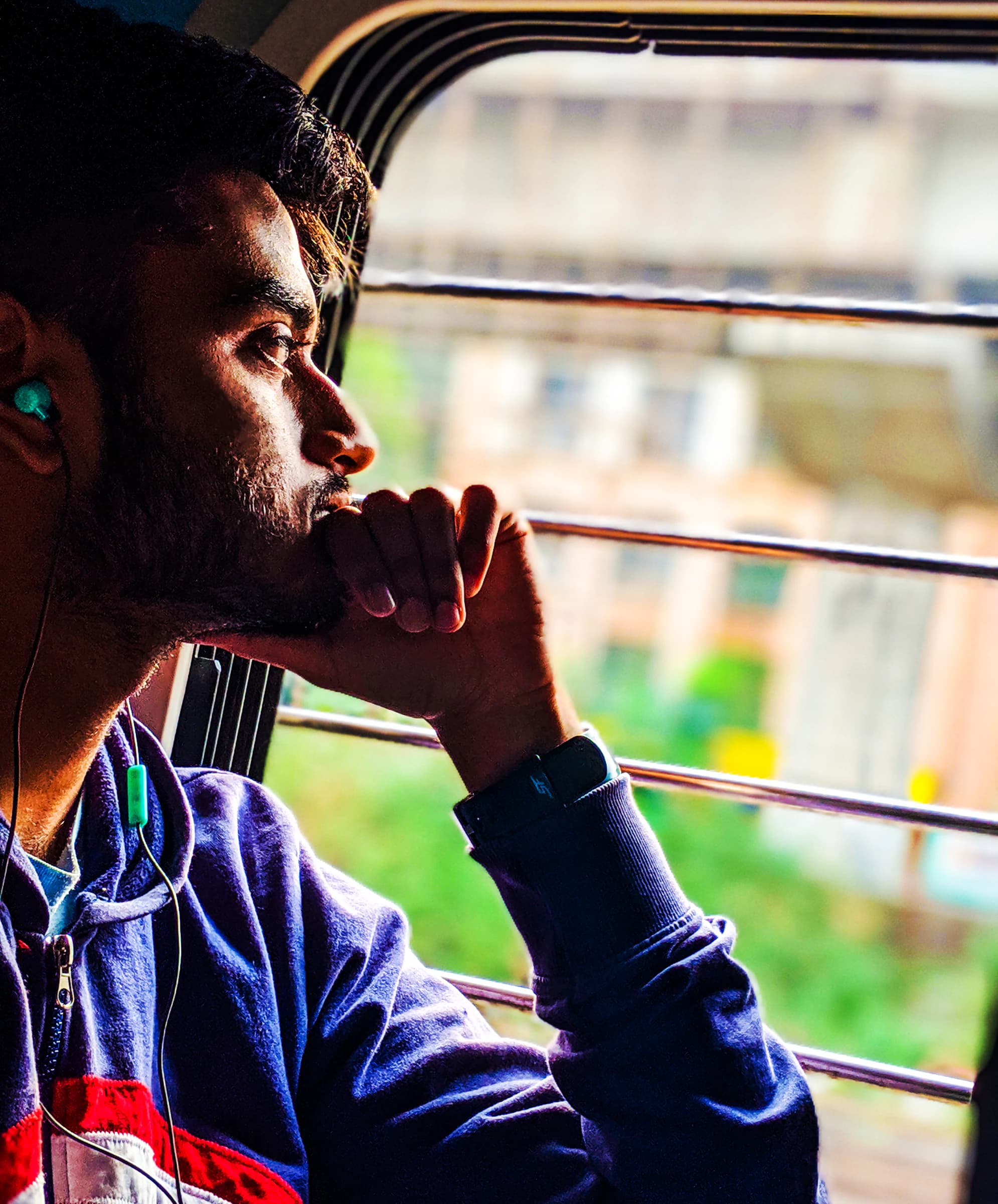 Portrait of Aniruddha Sil looking out of a train window